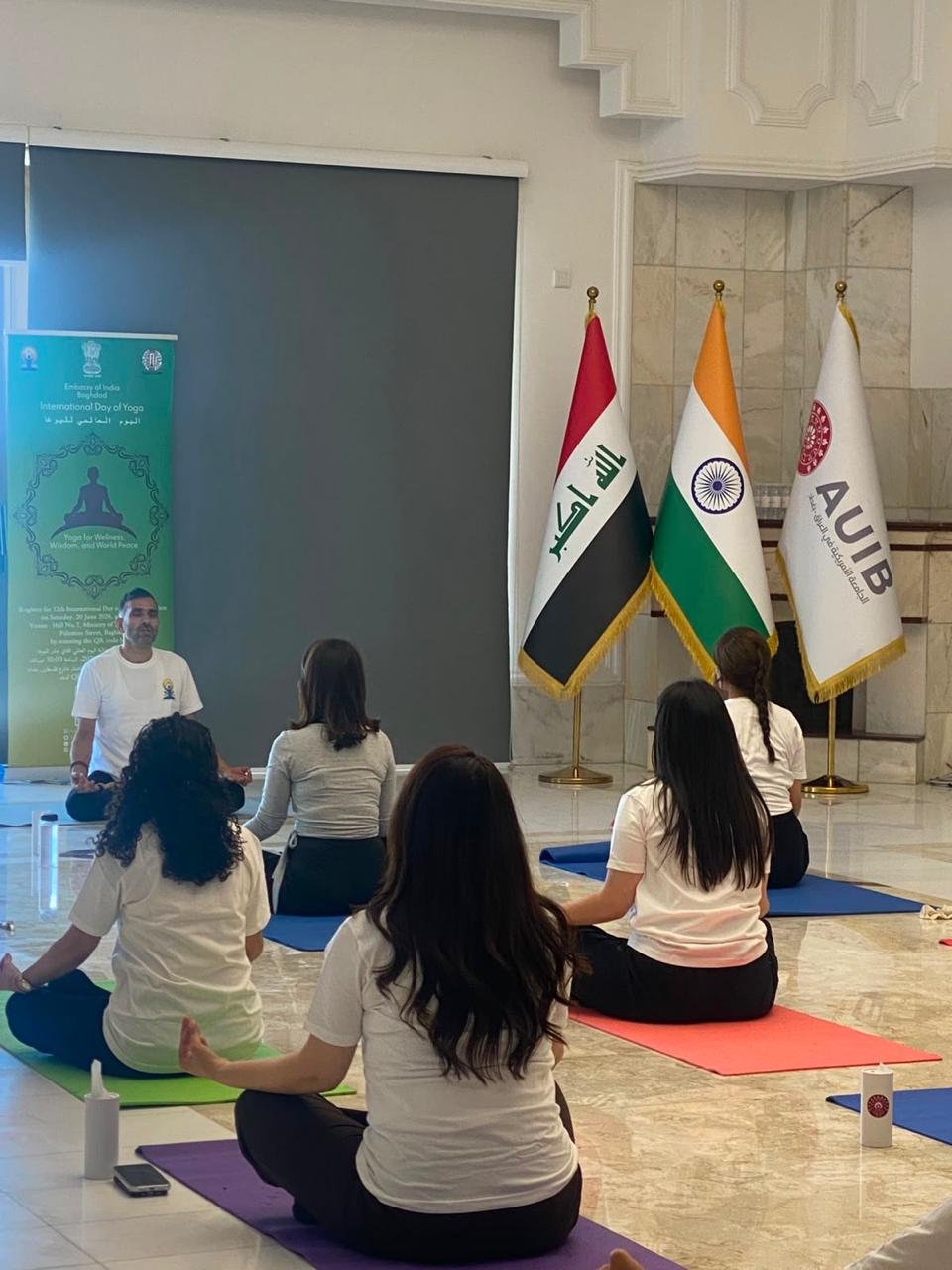 1 Embassy of India x American University of Iraq at Baghdad Let’s take a look back at one of the yoga sessions organised by the Indian Embassy for the 12th International Yoga Day in collaboration with the American University of Iraq, Baghdad (AUIB). Students and faculty members of the university participated in an interactive yoga session led by Dr. Dheeraj Prakash Joshi, Yoga Guru. The session focused on promoting mental well-being, managing academic stress, and encouraging healthy lifestyle practices. The session highlighted the importance of yoga as a holistic approach to enhancing physical health, improving mental resilience, and maintaining balance in everyday life. International Yoga Day may have passed, but the journey continues! Join the ongoing yoga classes at the Embassy of India. 